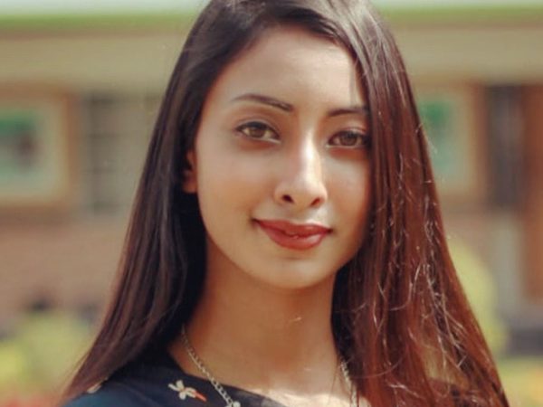 Headshot of Sunaya Amrin Rahman, who has long brown hair and is smiling slightly to the camera.