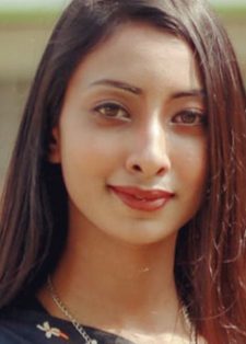 Headshot of Sunaya Amrin Rahman, who has long brown hair and is smiling slightly to the camera.